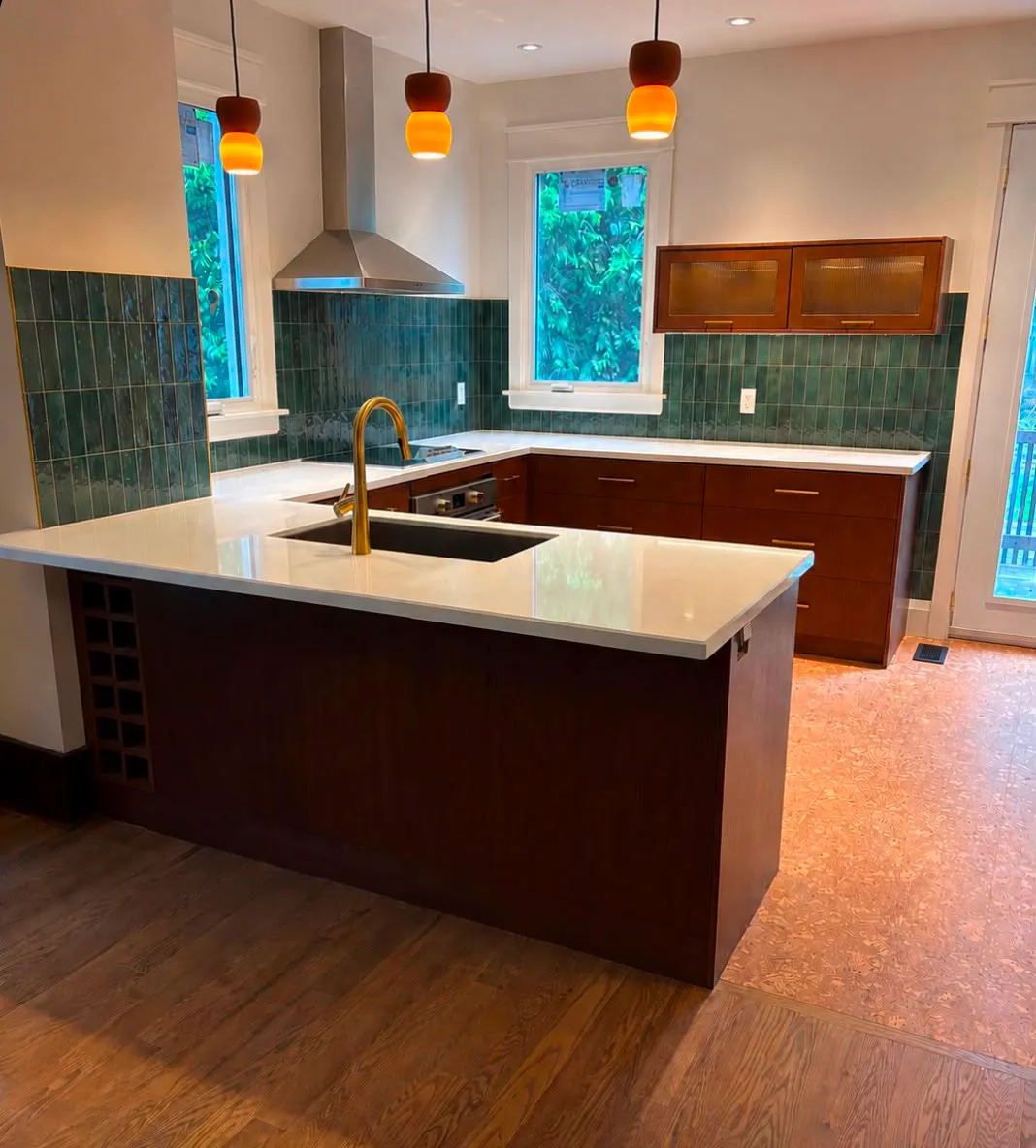 Modern kitchen with green tile backsplash and wood cabinets